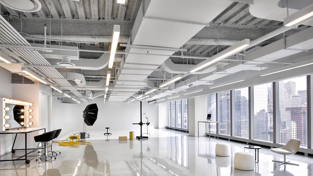 Cooper NeoRay Define linear fixtures are installed in a bright, open photography studio