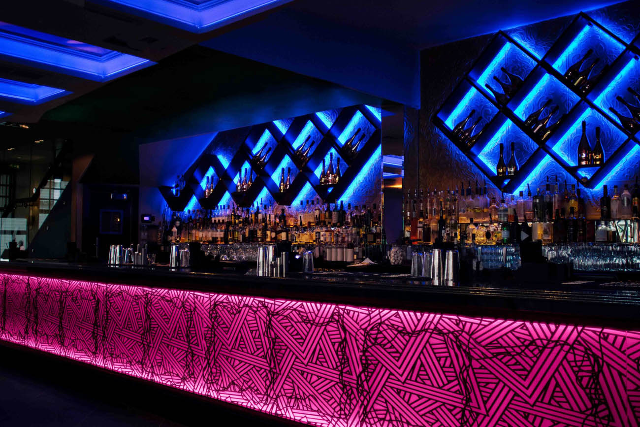 WAC Lighting Invisiled cove lighting installed behind a bar