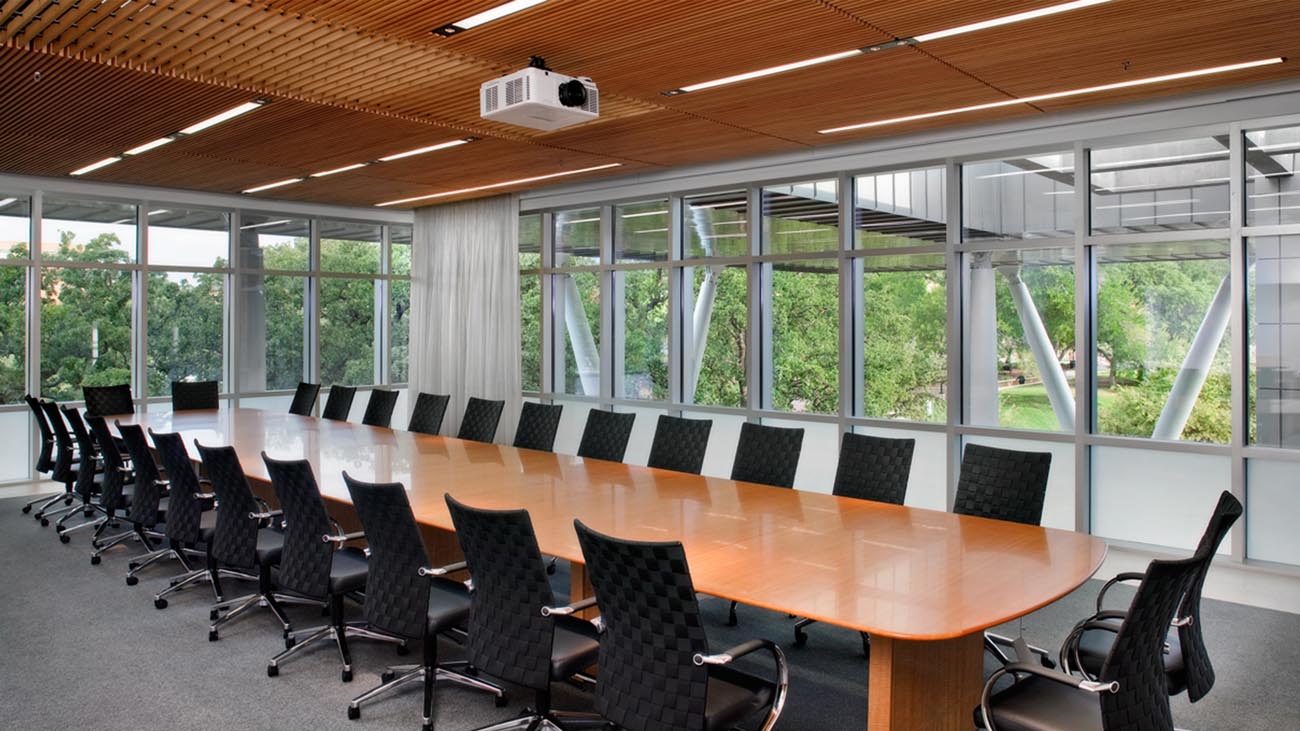 Cooper NeoRay Define linear fixtures are suspended above a board room table