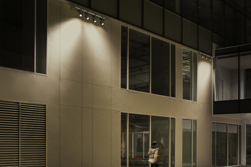 WE-EF FLC300 Projector Series lighting illuminates the side of a building