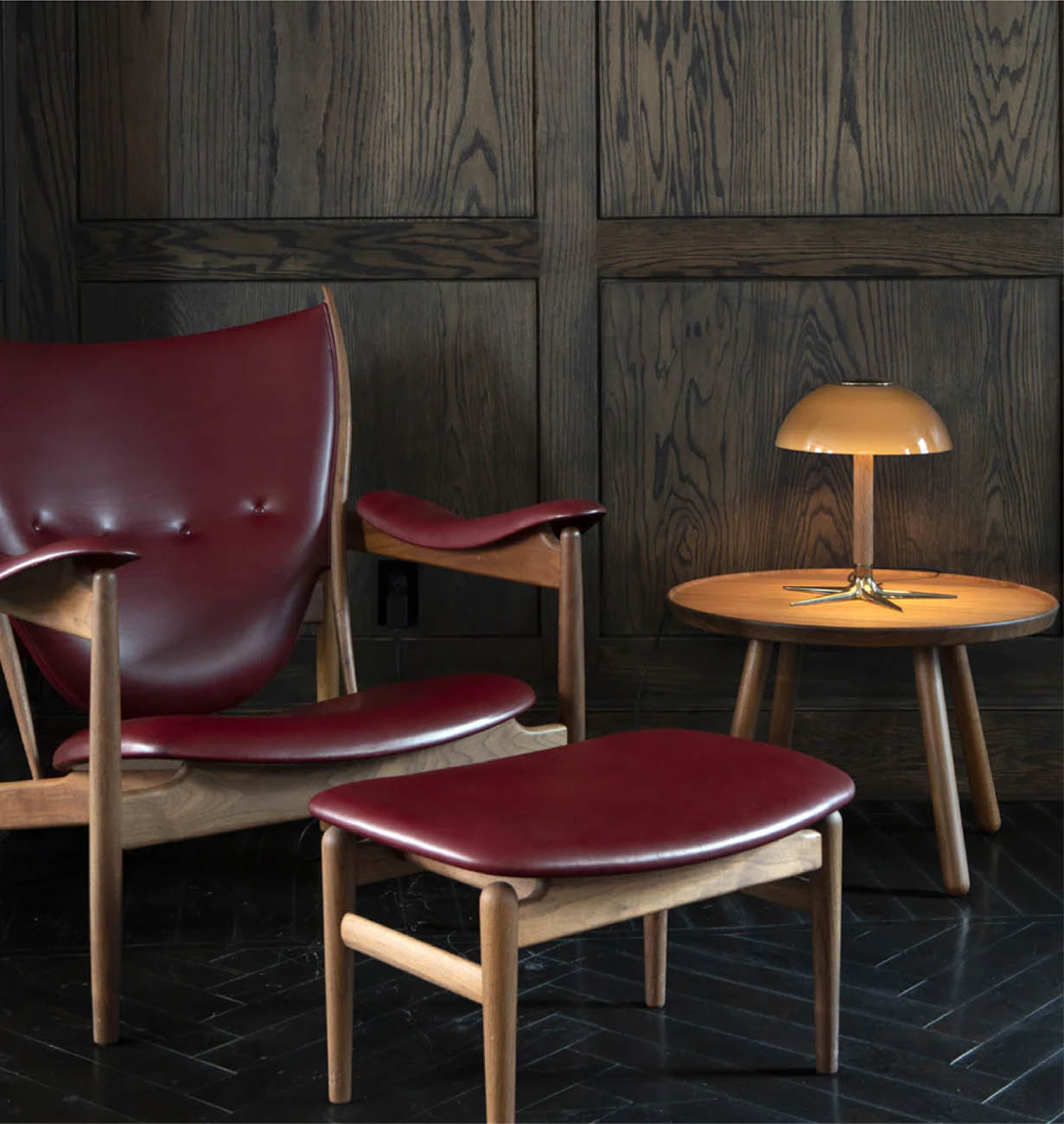 A wood and leather chair and ottoman set from Roll & Hill