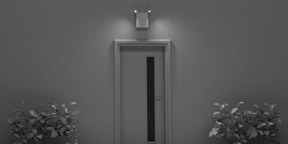 Black and white rendering of an Isolite OLLO emergency lighting installed over a door