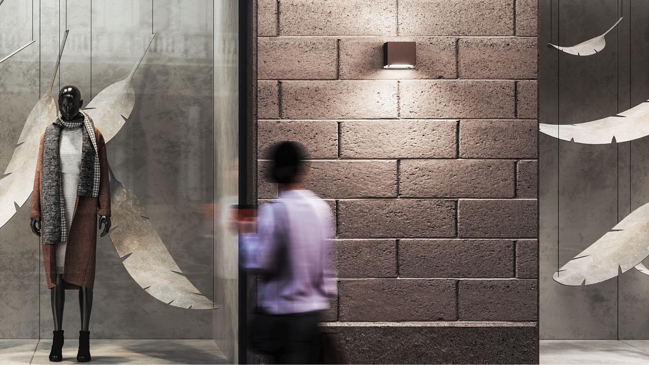 Allure by iGuzzini wallpack light on a wall outside of a store window