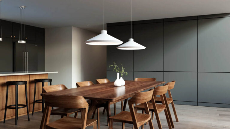 White Sonneman Koma pendant lights installed over a dining room table