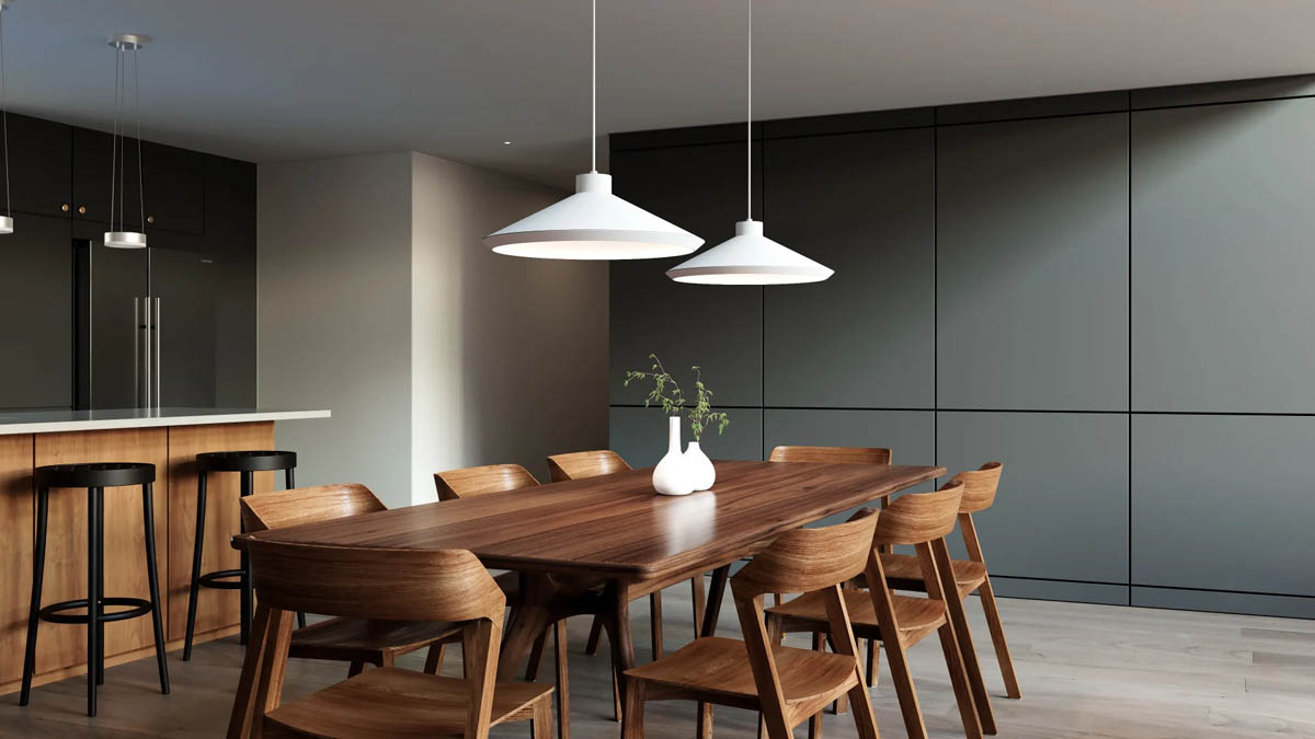 White Sonneman Koma pendant lights installed over a dining room table